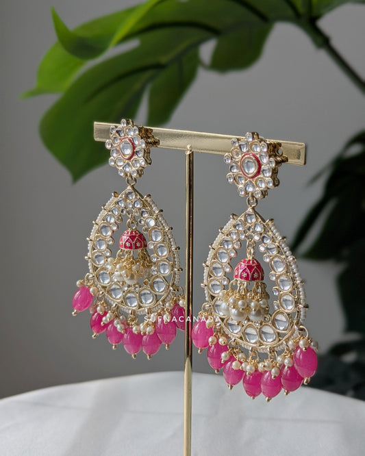 A pair of mid-sized golden jhumka earrings with pink pearl danglings displayed. Imitation jewelry. Pick-up in Ajax Ontario. Worldwide shipping available. Perfect for weddings, festival jewelry, indian Jewelry, kids jewelry, kundan jewelry, gifting, costume jewelry, fashion jewelry, Eid, onam, Diwali, karwachauth, navratri. Free shipping available. Jewelry for women. Indian jewelry in ajax durham toronto.