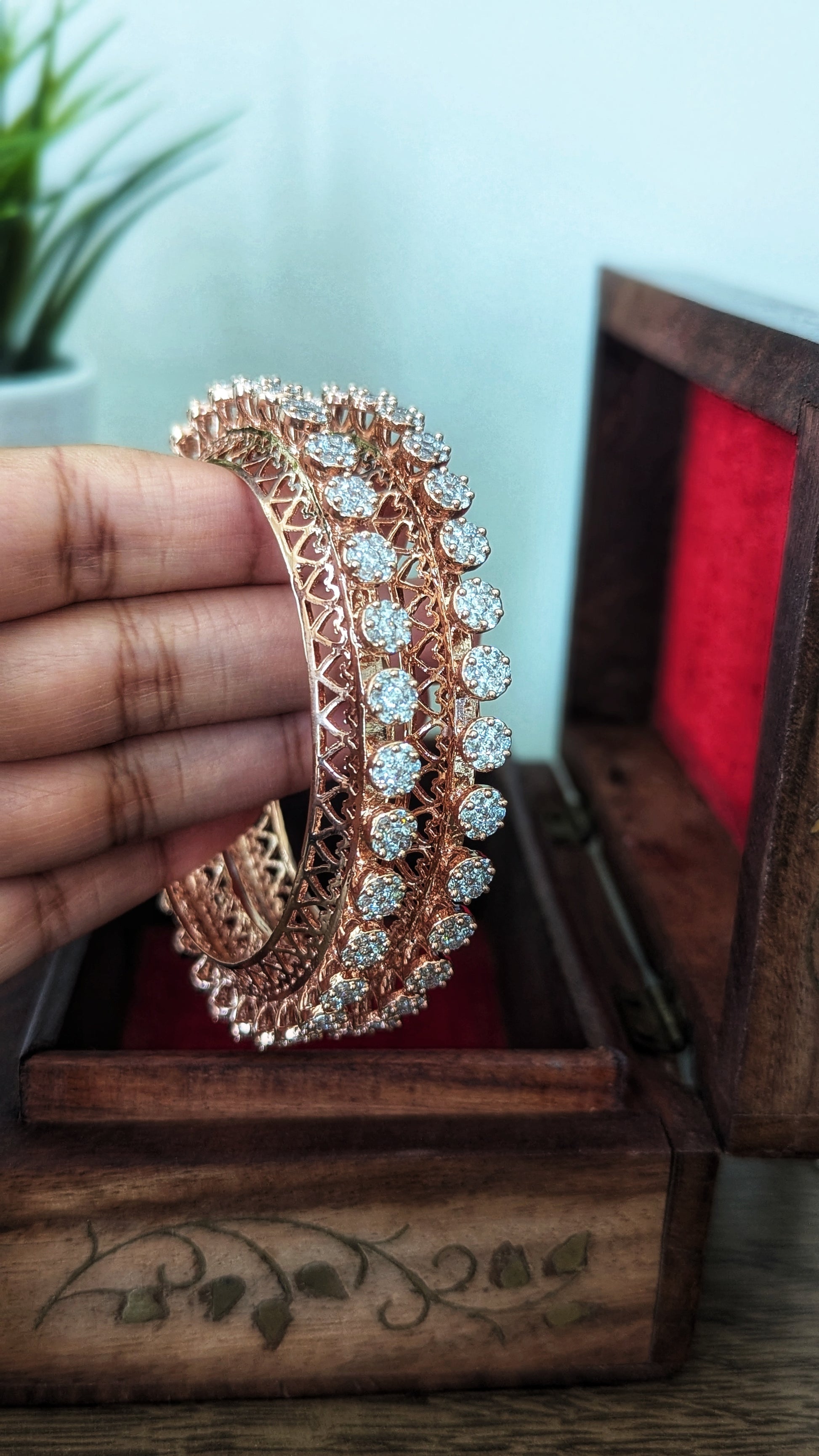 Rose gold bangles with diamond accents in a wooden box on a wooden surface. Pick-up in Ajax Ontario. Worldwide shipping available. Perfect for wedding, festival jewelry, indian Jewelry, kids jewelry, kundan jewelry, gifting, costume jewelry, fashion jewelry, Eid, onam, Diwali, karwachauth, navratri. Free shipping available. Jewelry for women. Indian jewelry in ajax durham region. Bollywood style jewelry.