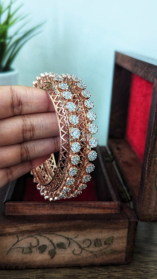 Rose gold bangles with diamond accents in a wooden box on a wooden surface. Pick-up in Ajax Ontario. Worldwide shipping available. Perfect for wedding, festival jewelry, indian Jewelry, kids jewelry, kundan jewelry, gifting, costume jewelry, fashion jewelry, Eid, onam, Diwali, karwachauth, navratri. Free shipping available. Jewelry for women. Indian jewelry in ajax durham region. Bollywood style jewelry.