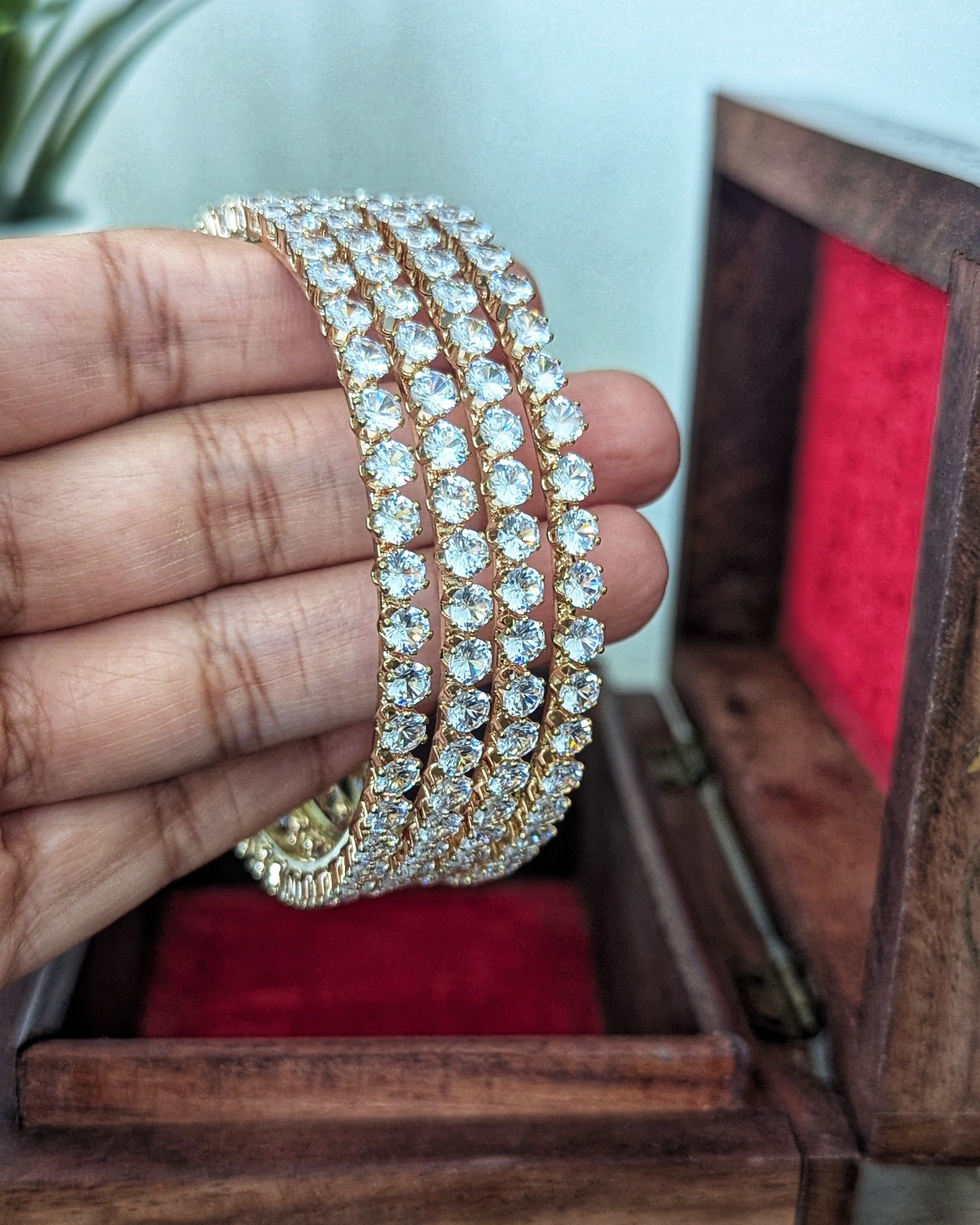 A set of four slim, gold-plated imitation bangles with a minimalist design and subtle sparkle. The bangles are stacked together on a soft fabric background, showcasing an everyday elegant style. Pick-up in Ajax Ontario. Worldwide shipping available. Perfect for wedding, festival jewelry, indian Jewelry, kids jewelry, kundan jewelry, gifting, costume jewelry, fashion jewelry, Eid, onam, Diwali, karwachauth, navratri. Free shipping available