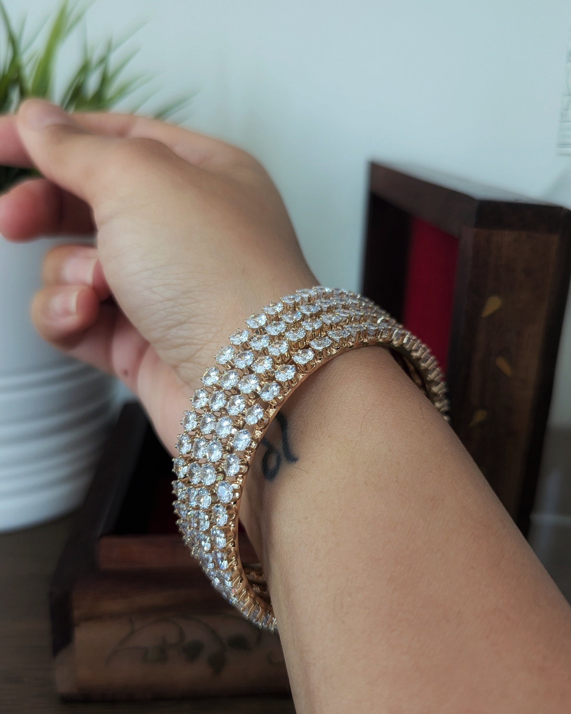 A set of four slim, gold-plated imitation bangles with a minimalist design and subtle sparkle. The bangles are stacked together on a soft fabric background, showcasing an everyday elegant style. Pick-up in Ajax Ontario. Worldwide shipping available. Perfect for wedding, festival jewelry, indian Jewelry, kids jewelry, kundan jewelry, gifting, costume jewelry, fashion jewelry, Eid, onam, Diwali, karwachauth, navratri. Free shipping available