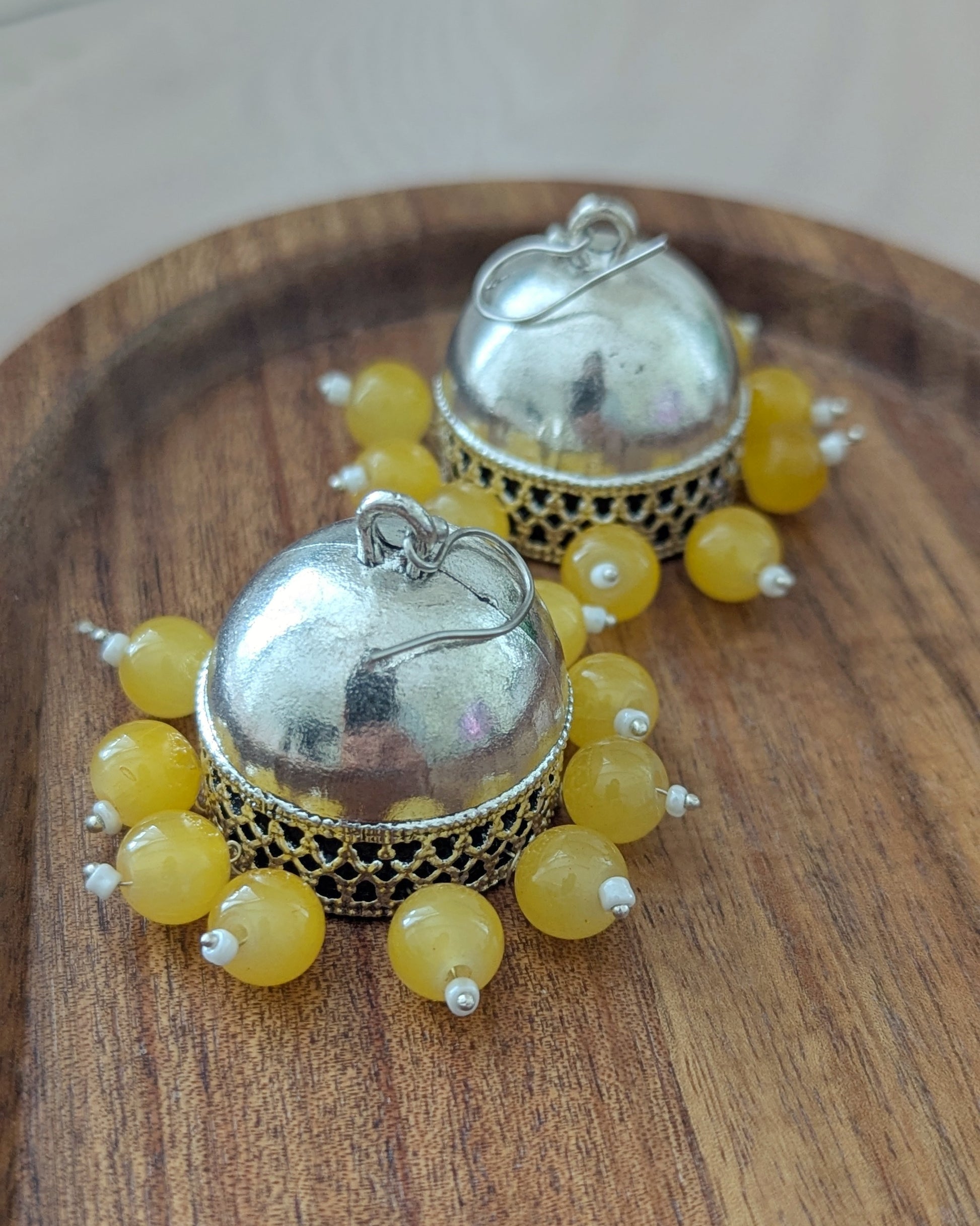 Oxidized Silver jhumkas with bright yellow beads. Pick-up in Ajax Ontario. Worldwide shipping available. Perfect for wedding, festival jewelry, indian Jewelry, kids jewelry, kundan jewelry, gifting, costume jewelry, fashion jewelry, Eid, onam, Diwali, karwachauth, navratri. Free shipping available. Jewelry for women. Indian jewelry in ajax durham region. Bollywood style jewelry.