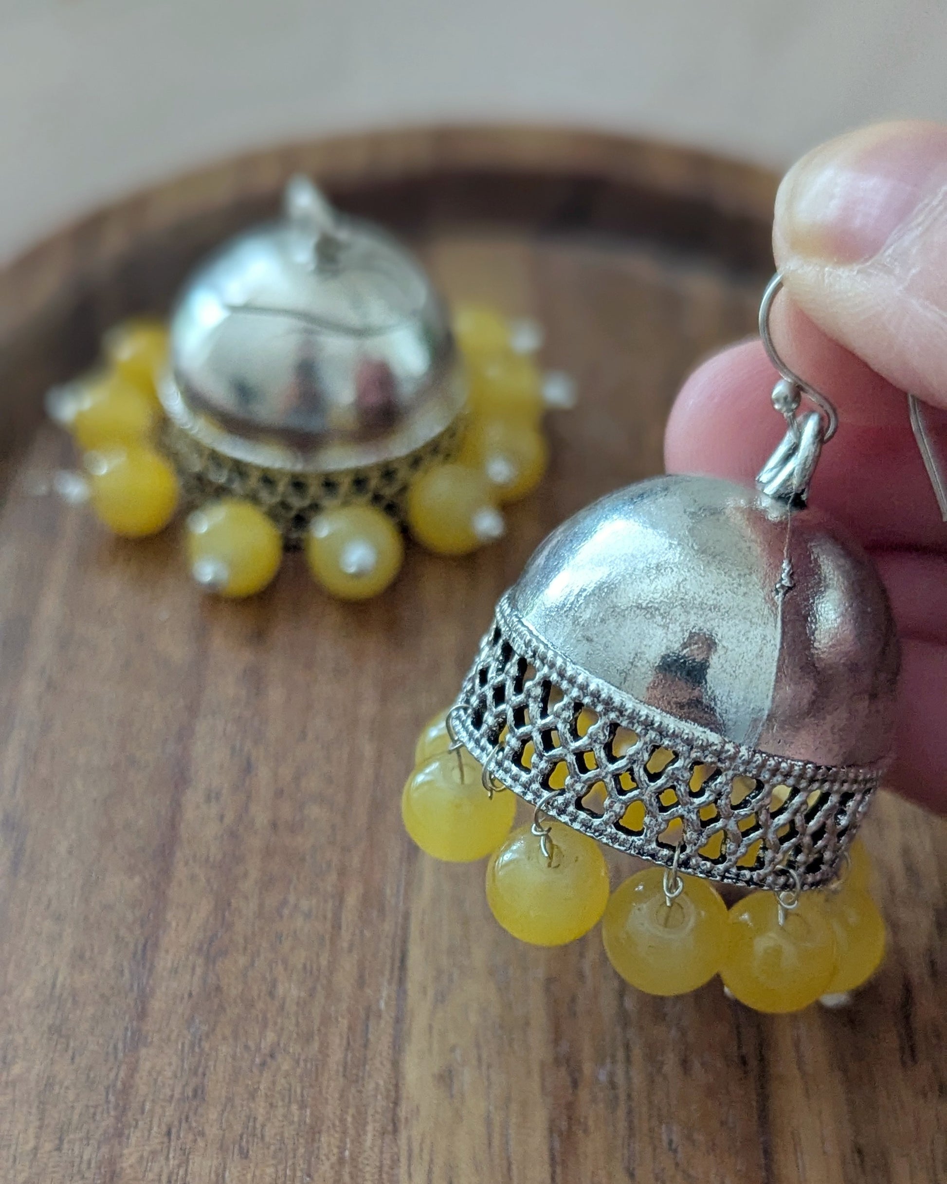 Oxidized Silver jhumkas with bright yellow beads. Pick-up in Ajax Ontario. Worldwide shipping available. Perfect for wedding, festival jewelry, indian Jewelry, kids jewelry, kundan jewelry, gifting, costume jewelry, fashion jewelry, Eid, onam, Diwali, karwachauth, navratri. Free shipping available. Jewelry for women. Indian jewelry in ajax durham region. Bollywood style jewelry.