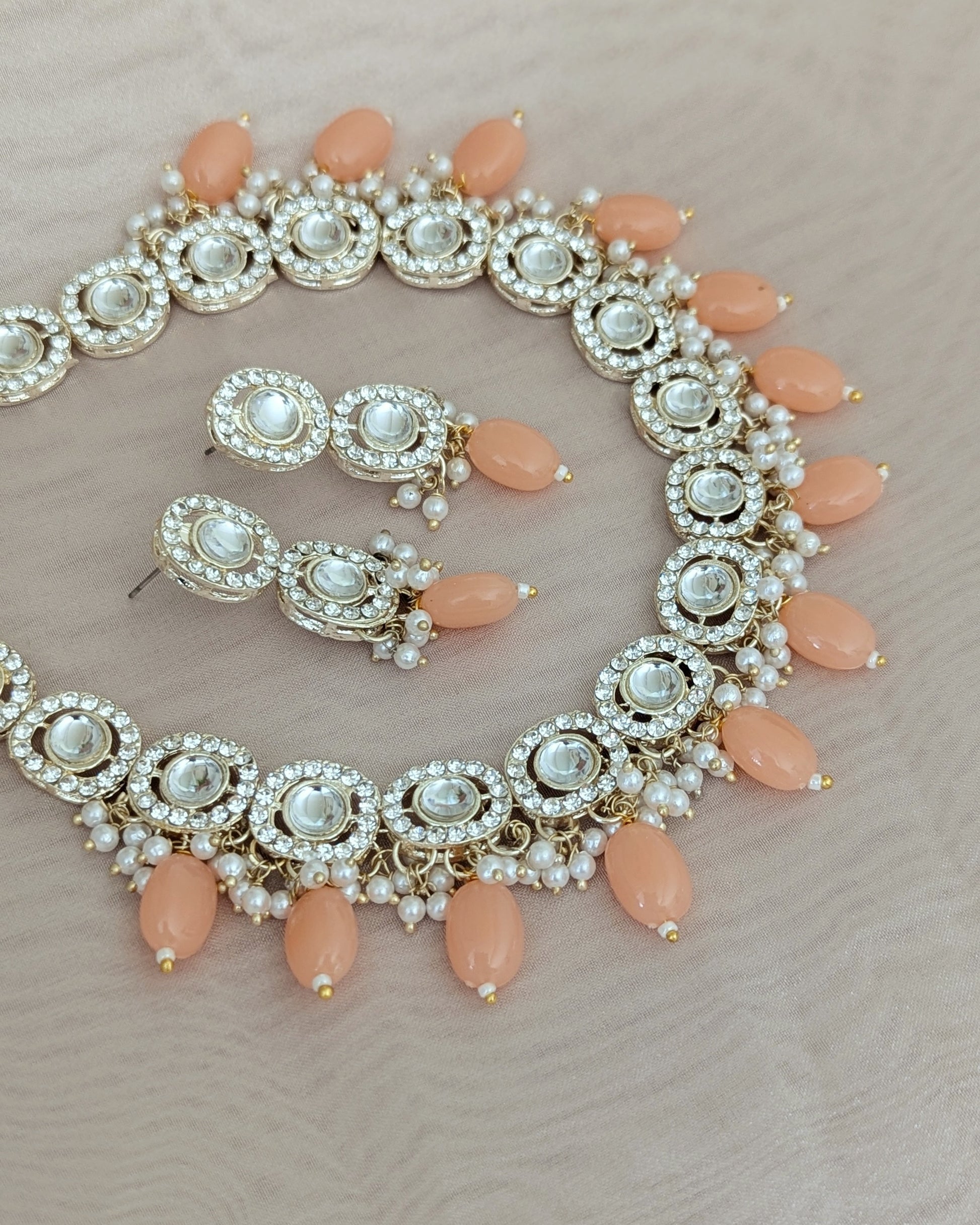 Dainty kundan necklace with peach color beads. Comes with matching drop earrings. Pick-up in Ajax Ontario. Worldwide shipping available. Perfect for wedding, festival jewelry, indian Jewelry, kids jewelry, kundan jewelry, gifting, costume jewelry, fashion jewelry, Eid, onam, Diwali, karwachauth, navratri. Free shipping available. Jewelry for women.