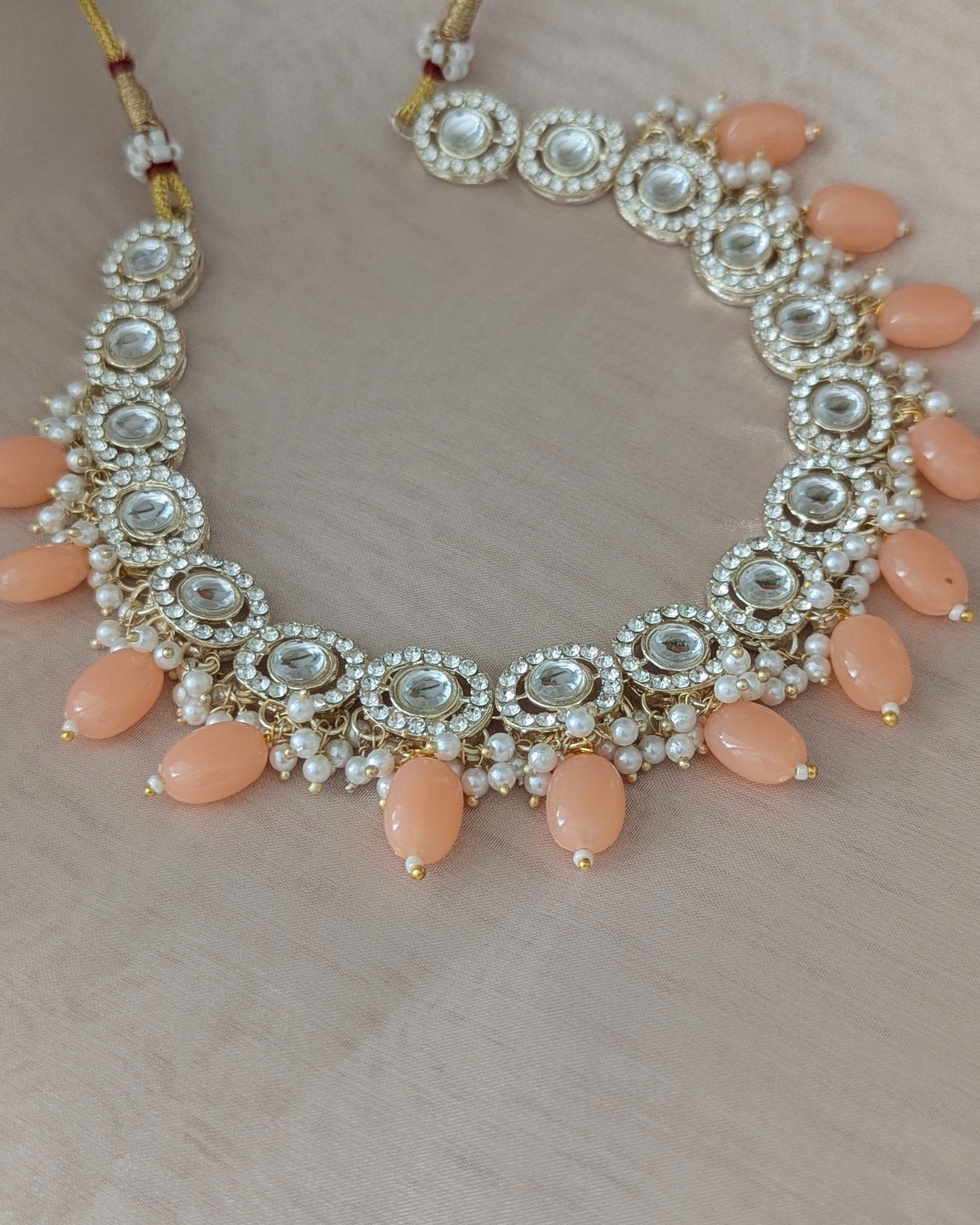 Dainty kundan necklace with peach color beads. Comes with matching drop earrings. Pick-up in Ajax Ontario. Worldwide shipping available. Perfect for wedding, festival jewelry, indian Jewelry, kids jewelry, kundan jewelry, gifting, costume jewelry, fashion jewelry, Eid, onam, Diwali, karwachauth, navratri. Free shipping available. Jewelry for women.