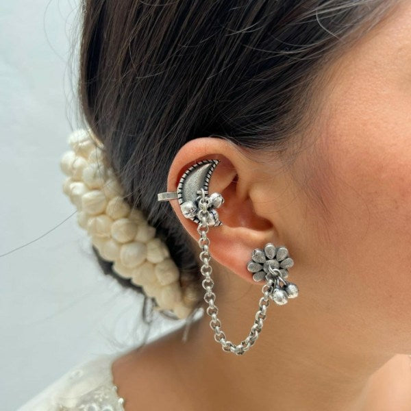A person wearing oxidized silver earcuffs with floral designs, securing the earcuffs in place with small hooks. Pick-up in Ajax Ontario. Worldwide shipping available. Perfect for wedding, festival jewelry, indian Jewelry, kids jewelry, kundan jewelry, gifting, costume jewelry, fashion jewelry, Eid, onam, Diwali, karwachauth, navratri. Free shipping available. Jewelry for women. Indian jewelry in ajax durham region.