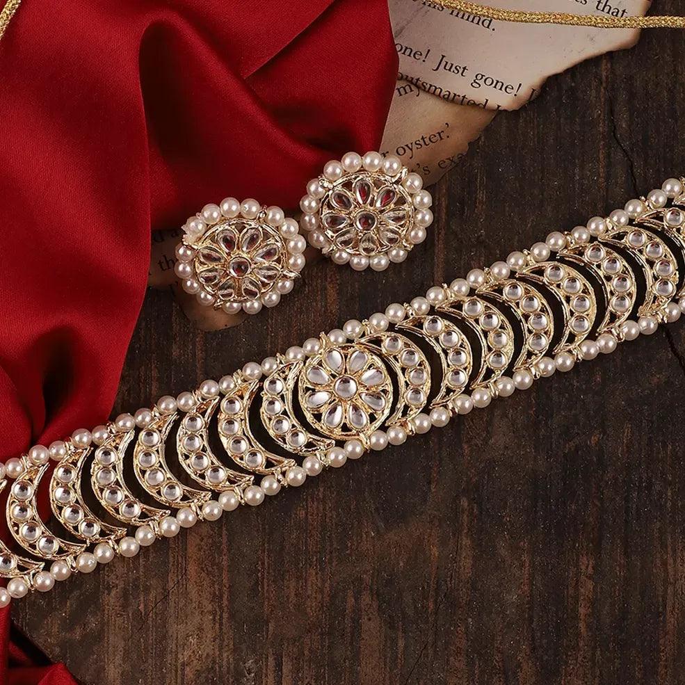 Kundan Pearl choker set with round stud earrings on a wooden surface. Imitation jewelry. Pick-up in Ajax Ontario. Worldwide shipping available. Perfect for weddings, festival jewelry, indian Jewelry, kids jewelry, kundan jewelry, gifting, costume jewelry, fashion jewelry, Eid, onam, Diwali, karwachauth, navratri. Free shipping available. Jewelry for women. Indian jewelry in ajax durham region. Bollywood style jewelry.