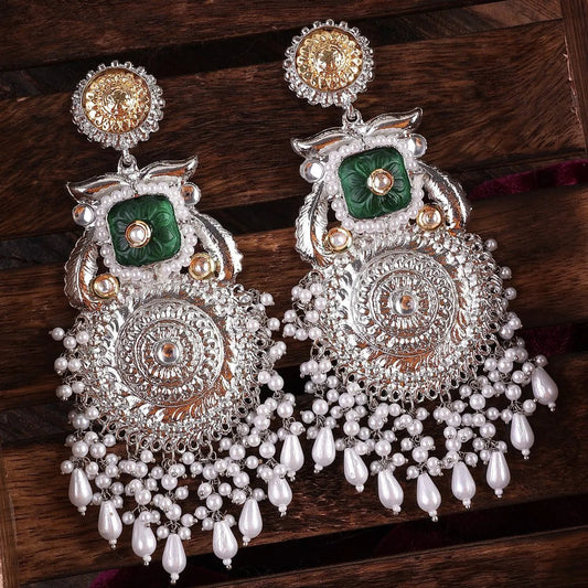 A pair of silver and green dual-tone chandbali earrings with intricate design and hanging embellishments. Pick-up in Ajax Ontario. Worldwide shipping available. Perfect for wedding, festival jewelry, indian Jewelry, kids jewelry, kundan jewelry, gifting, costume jewelry, fashion jewelry, Eid, onam, Diwali, karwachauth, navratri. Free shipping available. Jewelry for women. Indian jewelry in ajax durham region.