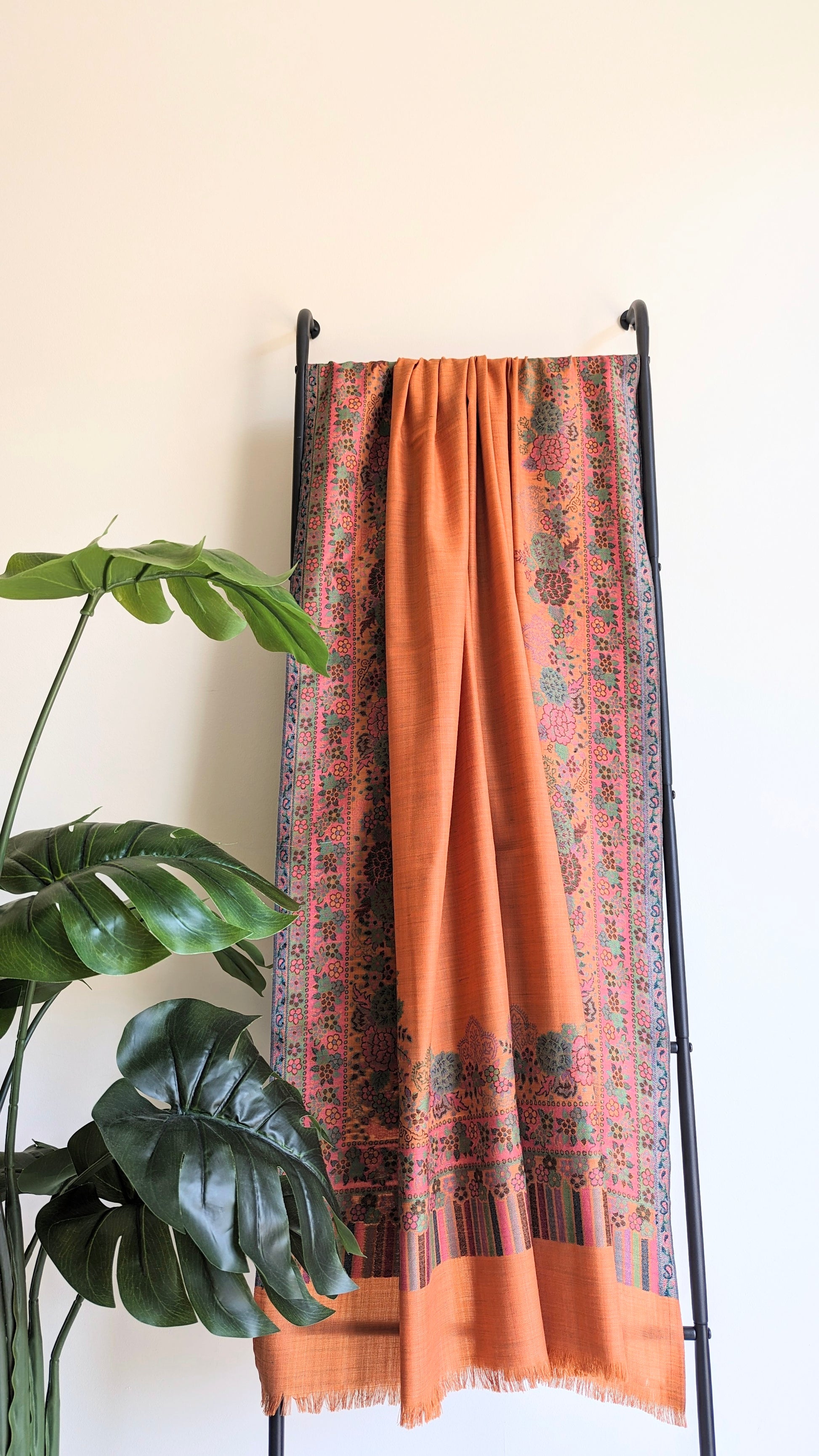 Pashmina shawl in orange color with Kani weave border, handmade in Kashmir, India.