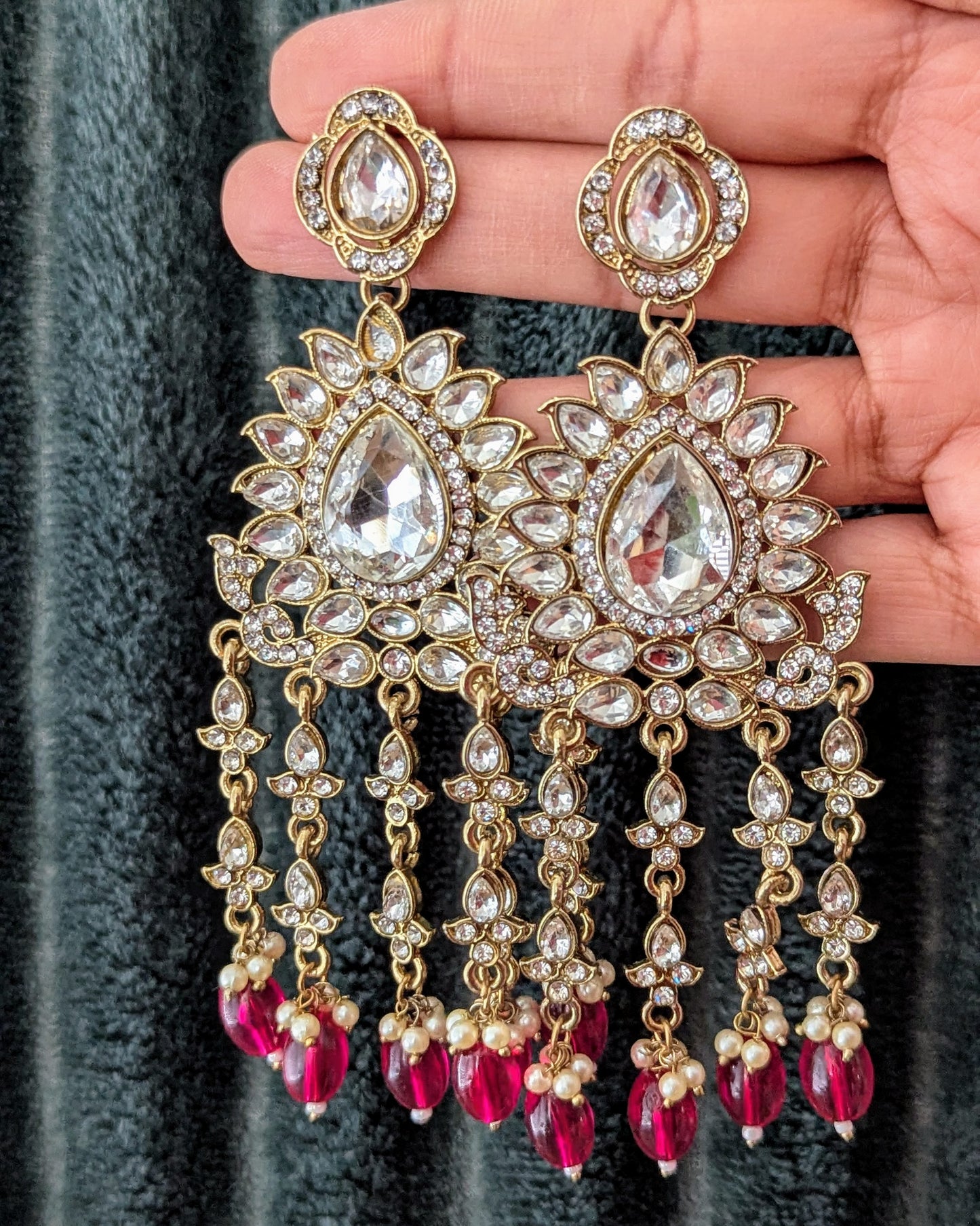 Statement zirconia chandbali danglers in pink/red. Perfect to match with any outfit or wear it as a contrast to a different color. Available for pick-up in Ajax, Ontario with worldwide shipping available. Pick-up in Ajax Ontario. Worldwide shipping available. Perfect for wedding, festival jewelry, indian Jewelry, kids jewelry, kundan jewelry, gifting, costume jewelry, fashion jewelry, Eid, onam, Diwali, karwachauth, navratri. Free shippi