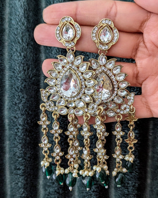 A pair of gold-colored chandbali earrings featuring green kundan and pearl danglers. Available for pickup in Ajax, Ontario and worldwide shipping.