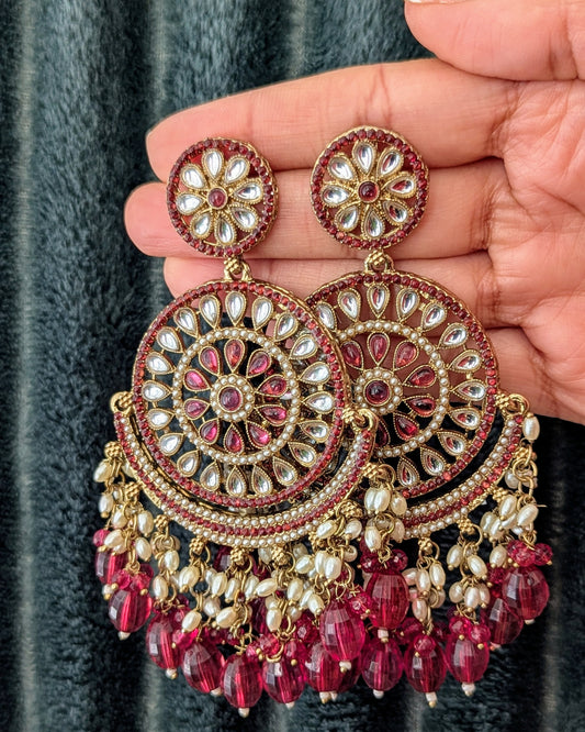 A pair of rani pink chandbali earrings with jadau work and kundan embellishments. Available for pickup in Ajax, Ontario and worldwide shipping.