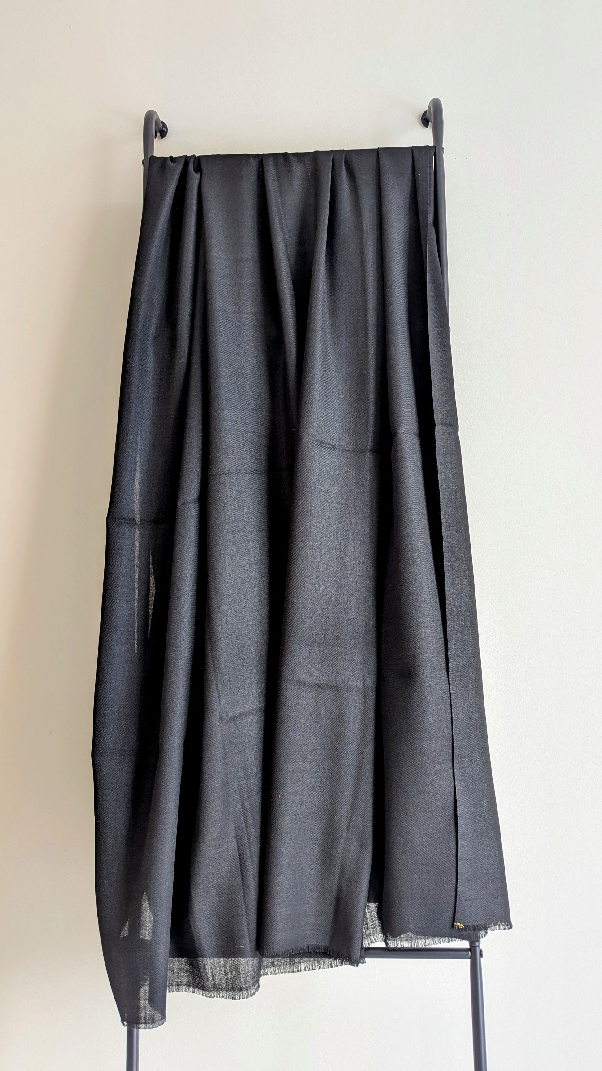 A classic plain black woolen lohi for men and women.