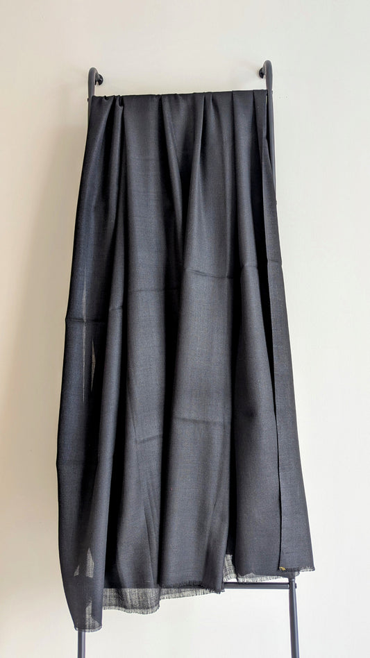 A classic plain black woolen lohi for men and women.