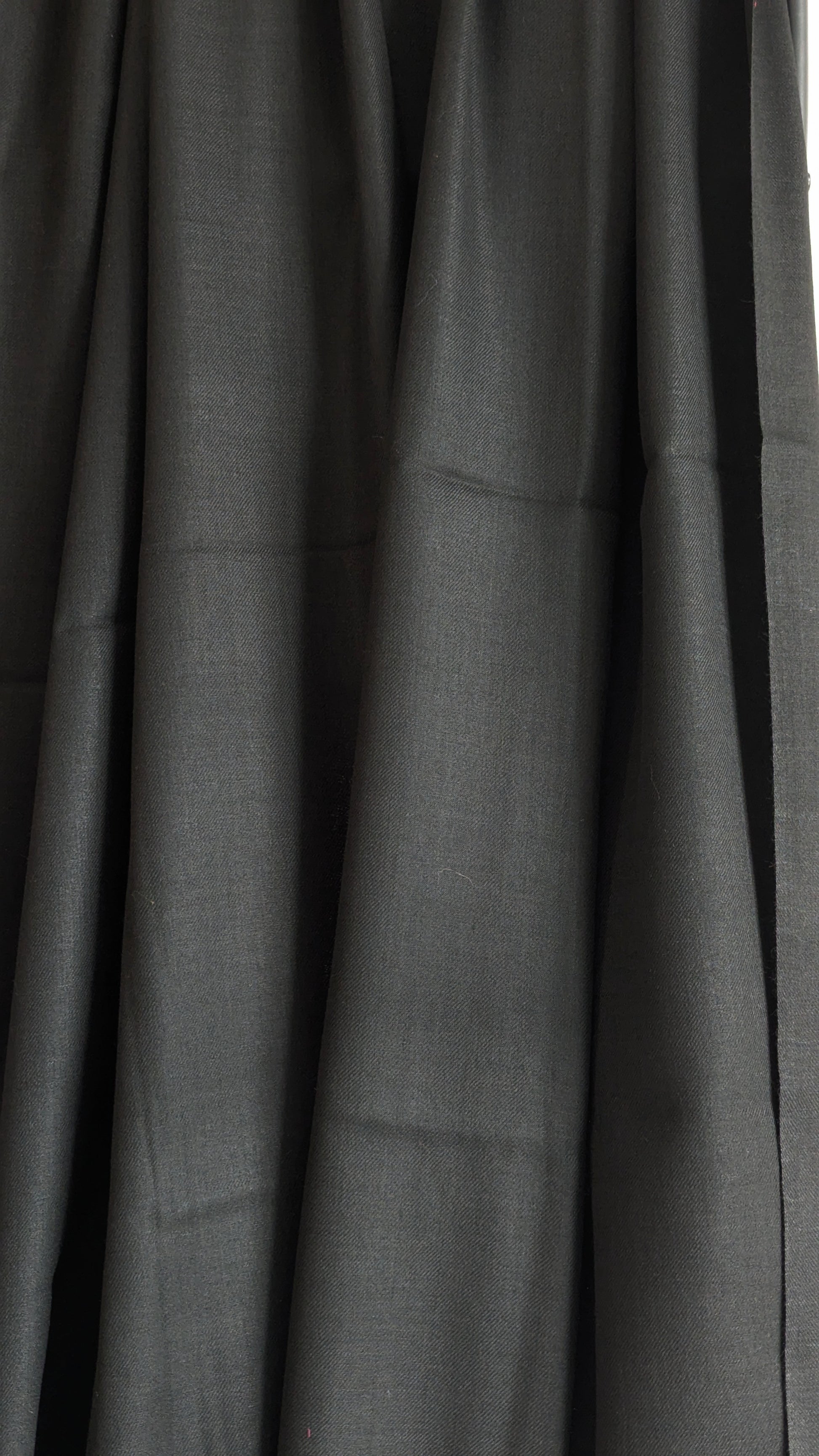 A classic plain black woolen lohi for men and women.