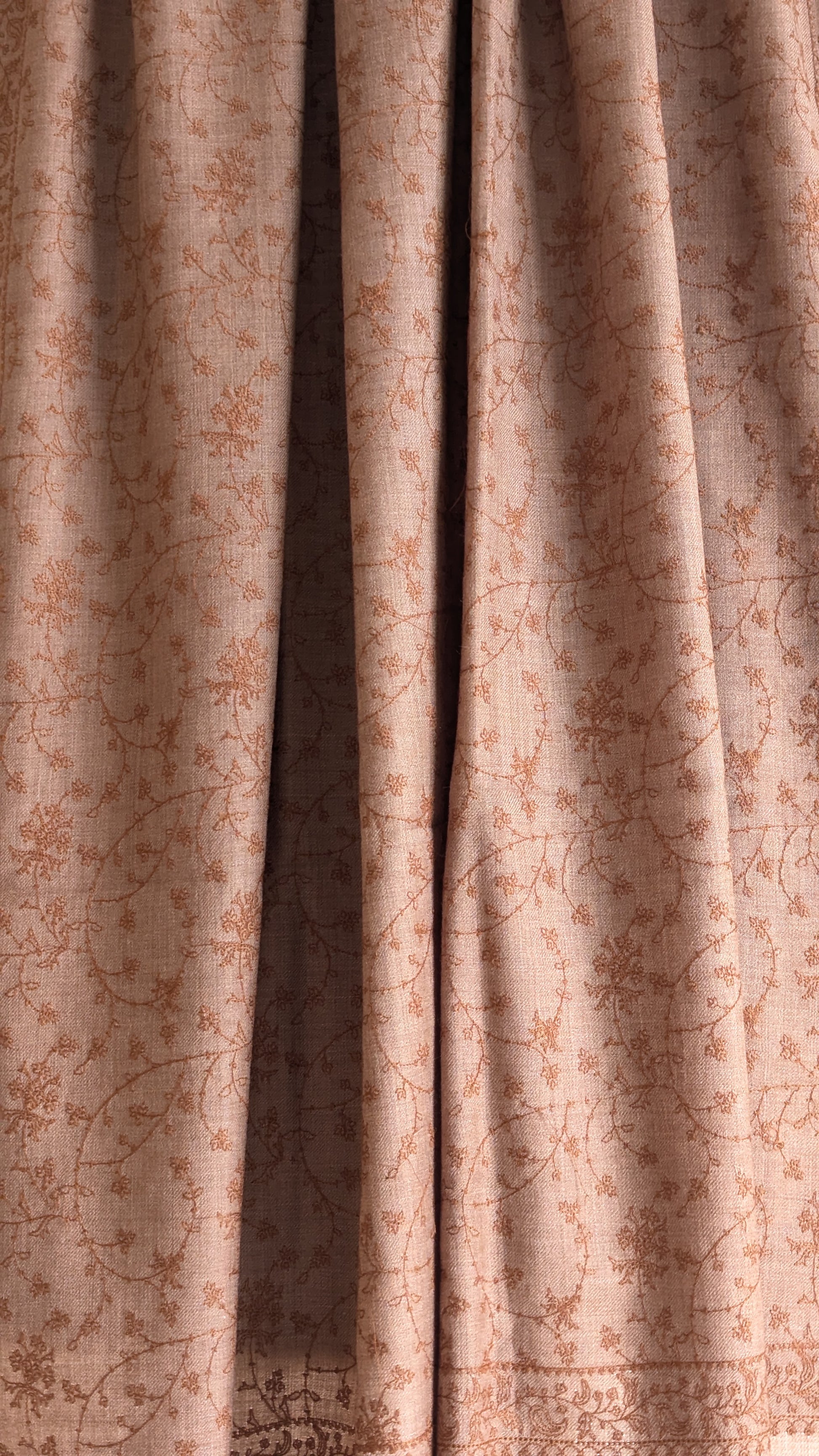 A brown woolen shawl with intricate hand embroidery.