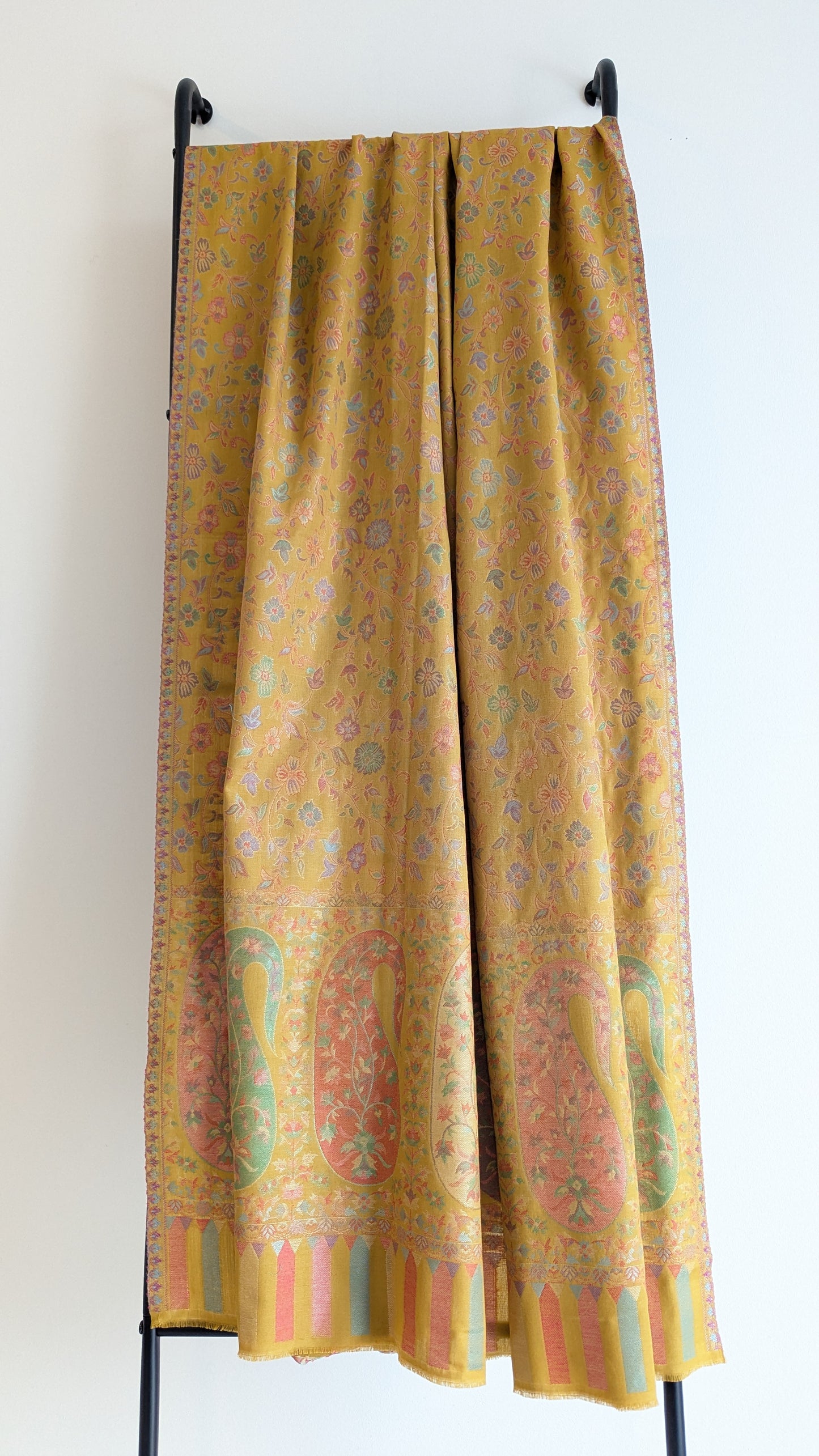 A mustard yellow lohi with multicolor patterns displayed.