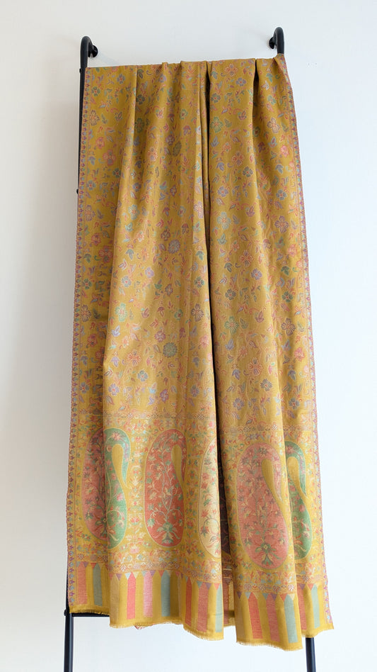 A mustard yellow lohi with multicolor patterns displayed.