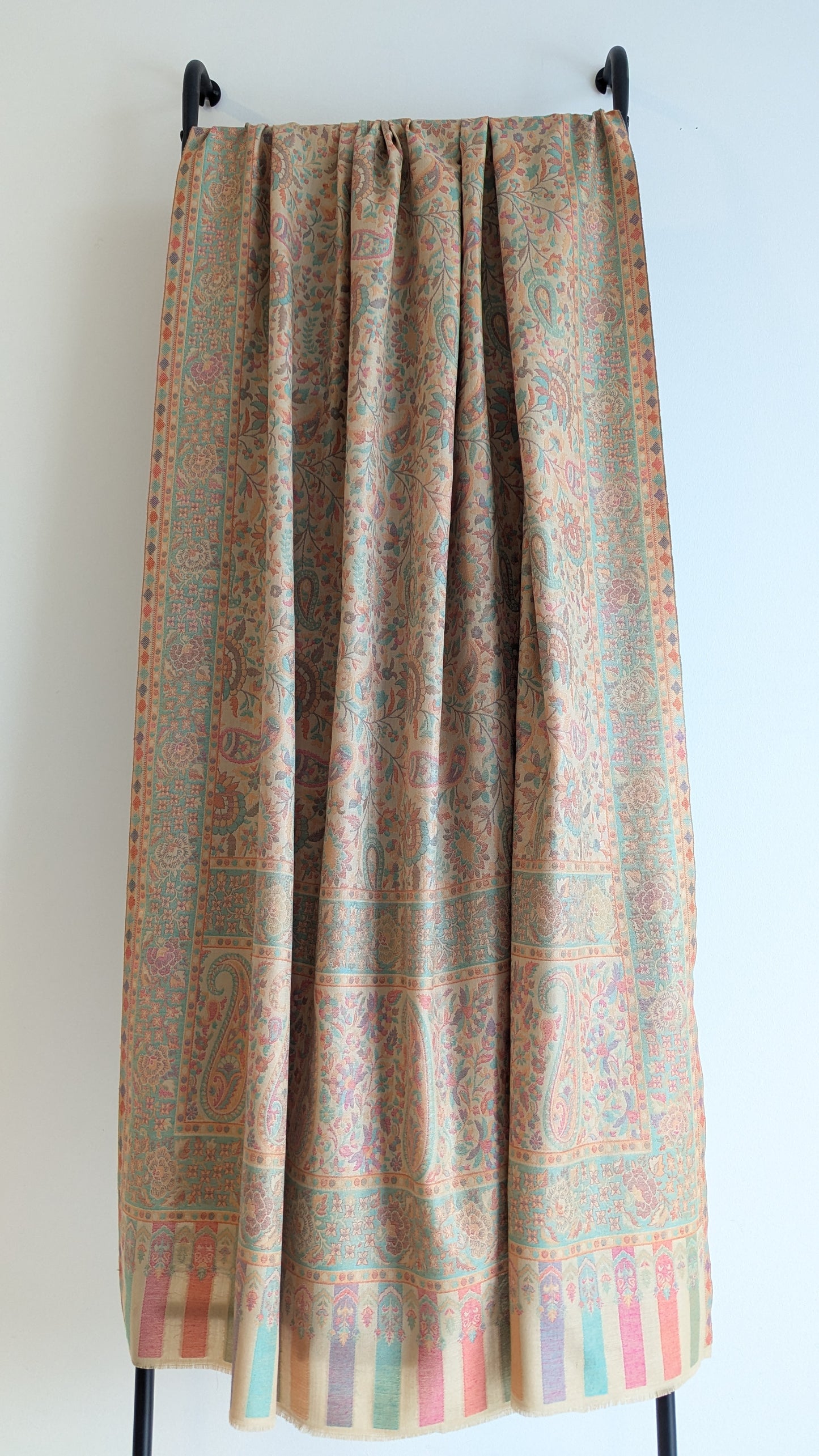 A beige lohi with multicolor patterns displayed.