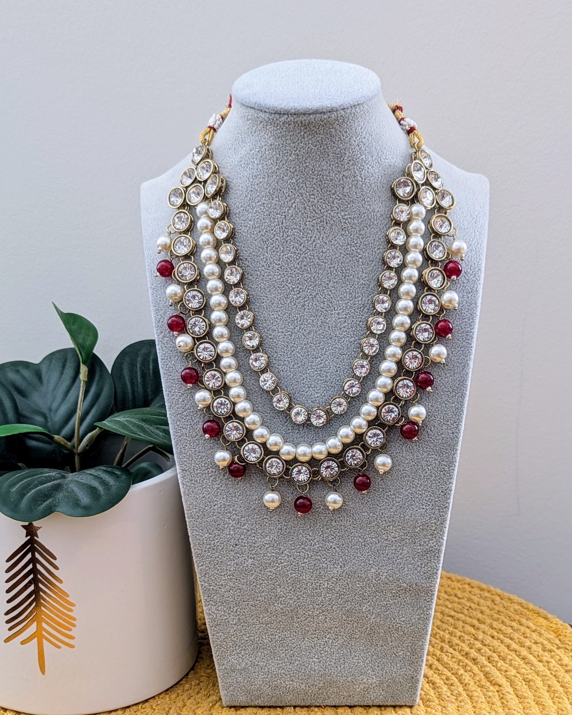 A maroon, white, and gold layered kundan necklace with pearl-like beads and polki embellishments. Imitation jewelry. Pick-up in Ajax Ontario. Worldwide shipping available. Perfect for weddings, festival jewelry, indian Jewelry, kids jewelry, kundan jewelry, gifting, costume jewelry, fashion jewelry, Eid, onam, Diwali, karwachauth, navratri. Free shipping available. Jewelry for women. Indian jewelry in ajax durham toronto.