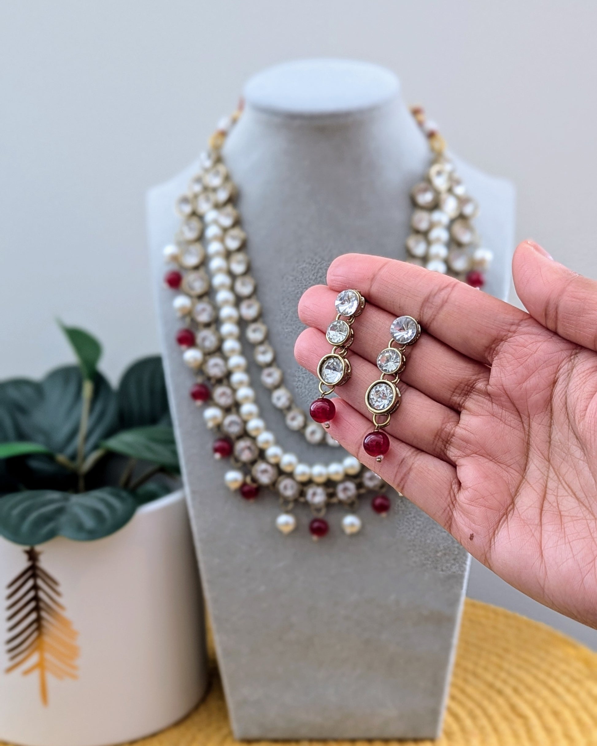 A maroon, white, and gold layered kundan necklace with pearl-like beads and polki embellishments. Imitation jewelry. Pick-up in Ajax Ontario. Worldwide shipping available. Perfect for weddings, festival jewelry, indian Jewelry, kids jewelry, kundan jewelry, gifting, costume jewelry, fashion jewelry, Eid, onam, Diwali, karwachauth, navratri. Free shipping available. Jewelry for women. Indian jewelry in ajax durham toronto.