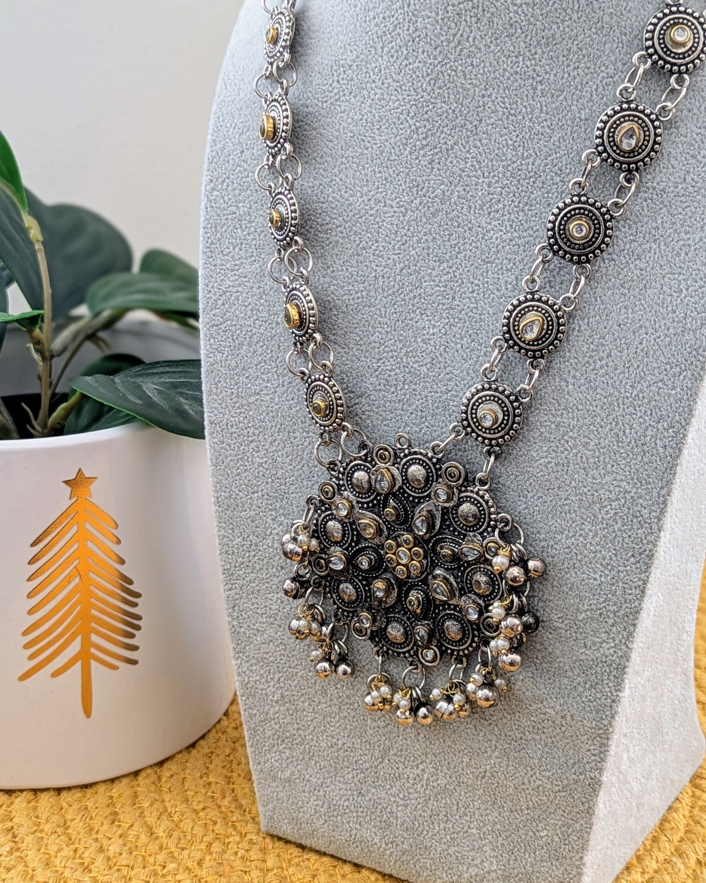 A long oxidized silver necklace with a statement Kundan pendant displayed on a mannequin. Pick-up in Ajax Ontario. Worldwide shipping available. Perfect for weddings, festival jewelry, indian Jewelry, kids jewelry, kundan jewelry, gifting, costume jewelry, fashion jewelry, Eid, onam, Diwali, karwachauth, navratri. Free shipping available. Jewelry for women. Indian jewelry in ajax toronto Canada