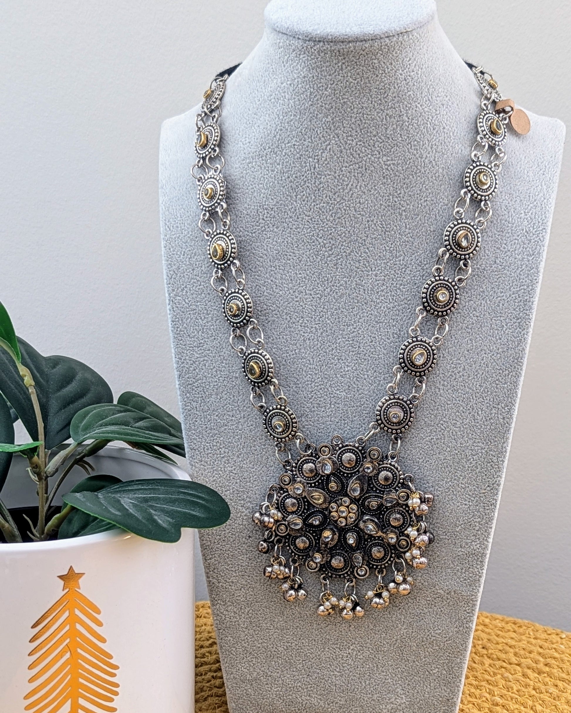 A long oxidized silver necklace with a statement Kundan pendant displayed on a mannequin. Pick-up in Ajax Ontario. Worldwide shipping available. Perfect for weddings, festival jewelry, indian Jewelry, kids jewelry, kundan jewelry, gifting, costume jewelry, fashion jewelry, Eid, onam, Diwali, karwachauth, navratri. Free shipping available. Jewelry for women. Indian jewelry in ajax toronto Canada