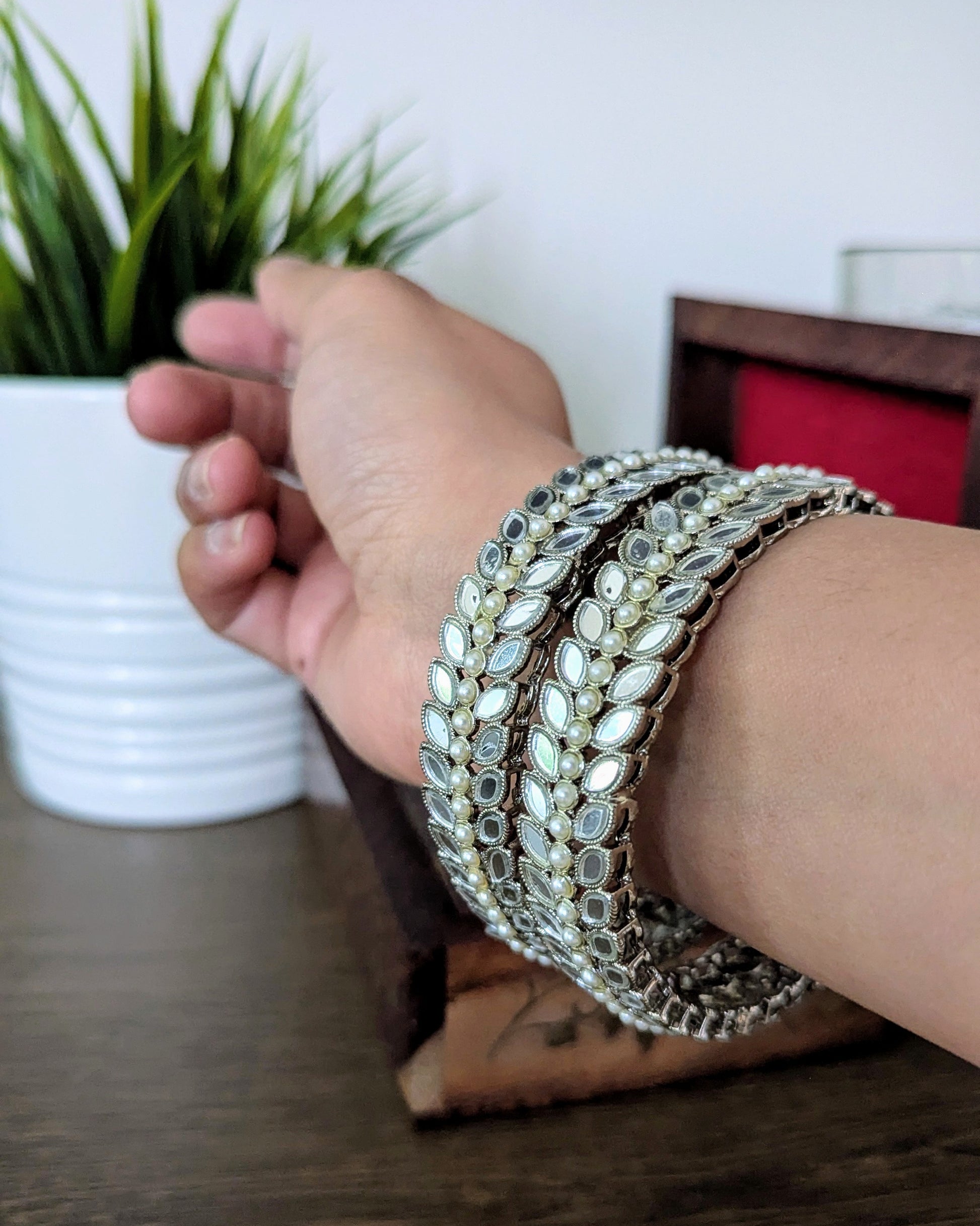 A pair of beautiful silver mirror bangles with pearl detailing. Imitation jewelry. Pick-up in Ajax Ontario. Worldwide shipping available. Perfect for weddings, festival jewelry, indian Jewelry, kids jewelry, kundan jewelry, gifting, costume jewelry, fashion jewelry, Eid, onam, Diwali, karwachauth, navratri. Free shipping available. Jewelry for women. Indian jewelry in ajax durham region. Bollywood style jewelry.