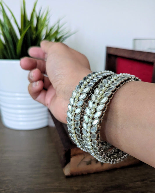 A pair of beautiful silver mirror bangles with pearl detailing. Imitation jewelry. Pick-up in Ajax Ontario. Worldwide shipping available. Perfect for weddings, festival jewelry, indian Jewelry, kids jewelry, kundan jewelry, gifting, costume jewelry, fashion jewelry, Eid, onam, Diwali, karwachauth, navratri. Free shipping available. Jewelry for women. Indian jewelry in ajax durham region. Bollywood style jewelry.