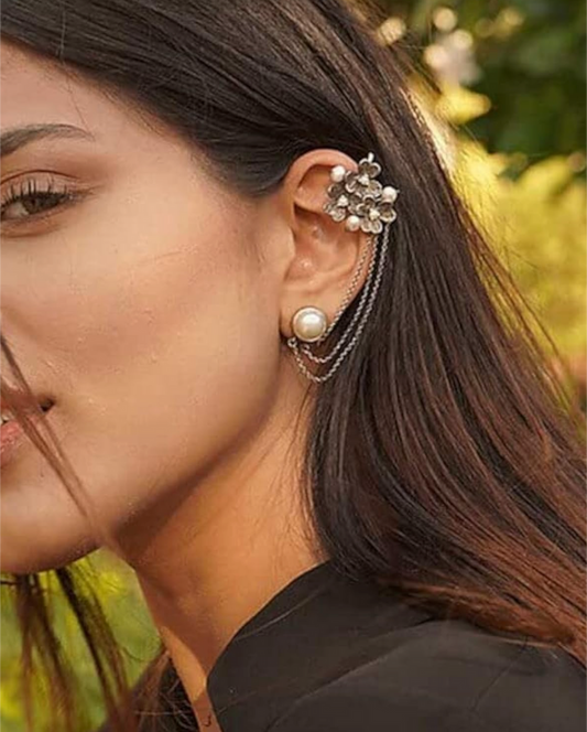 A person wearing oxidized silver earcuffs with floral designs, securing the earcuffs in place with small hooks. Pick-up in Ajax Ontario. Worldwide shipping available. Perfect for wedding, festival jewelry, indian Jewelry, kids jewelry, kundan jewelry, gifting, costume jewelry, fashion jewelry, Eid, onam, Diwali, karwachauth, navratri. Free shipping available. Jewelry for women. Indian jewelry in ajax durham region.