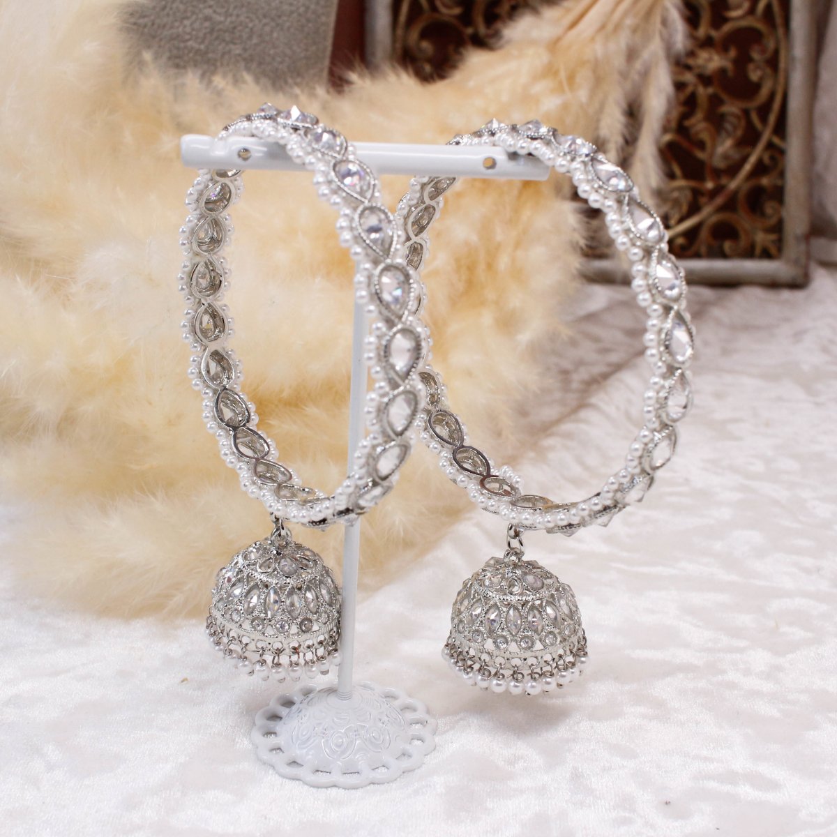 A pair of traditional silver bangles with pearl detailing and attached jhumka earrings. Available for pickup in Ajax, Ontario and worldwide shipping.