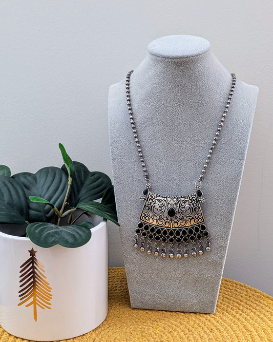 A long oxidized silver necklace with a statement pendant displayed on a mannequin bust. Pick-up in Ajax Ontario. Worldwide shipping available. Perfect for weddings, festival jewelry, indian Jewelry, kids jewelry, kundan jewelry, gifting, costume jewelry, fashion jewelry, Eid, onam, Diwali, karwachauth, navratri. Free shipping available. Jewelry for women. Indian jewelry in ajax toronto Canada
