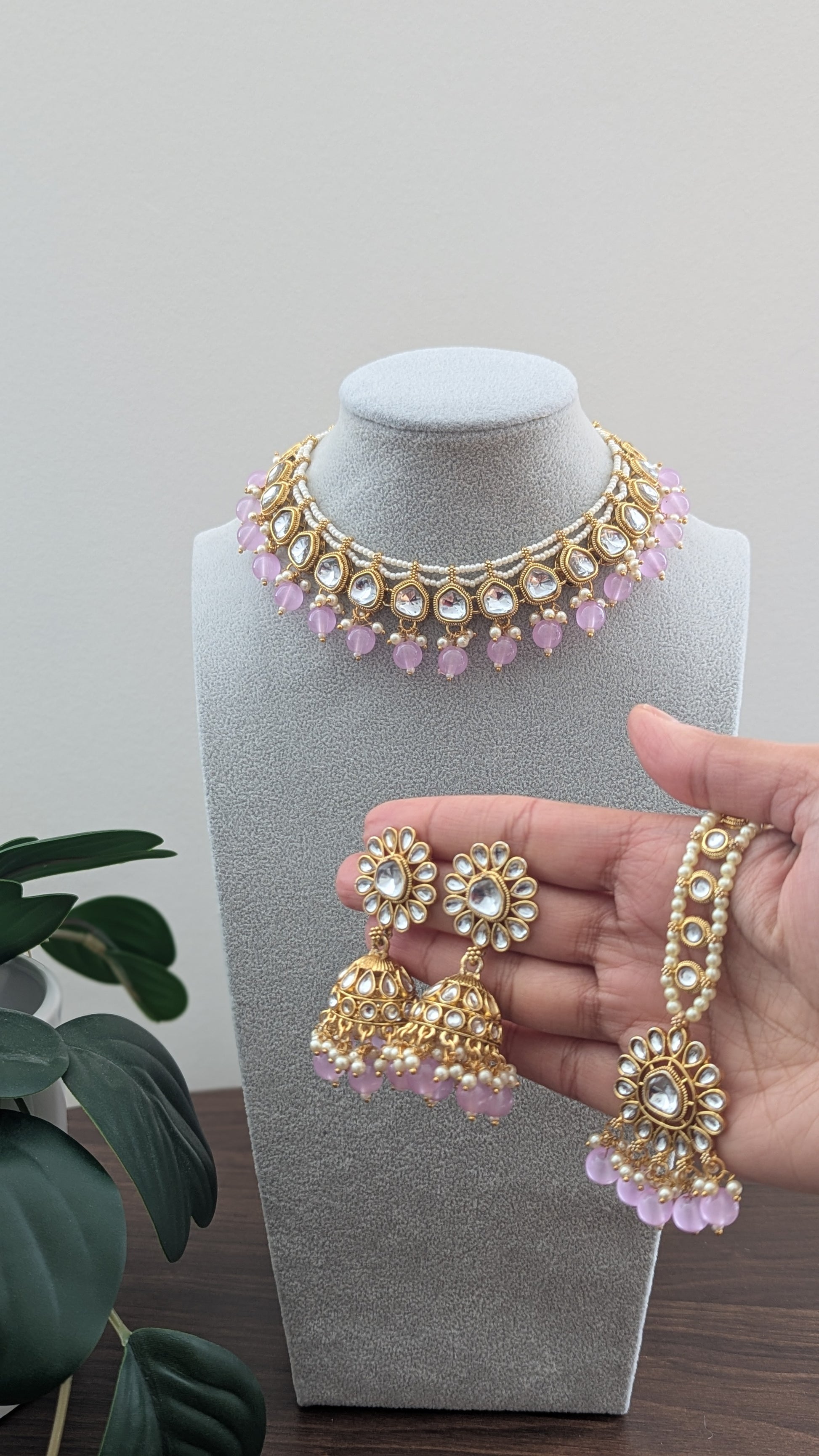 Beautiful small sized necklace in purple color with kundan design and small pearls. Comes with matching pink earrings and a tikka. Available at Sufna Canada in Ajax, Durham