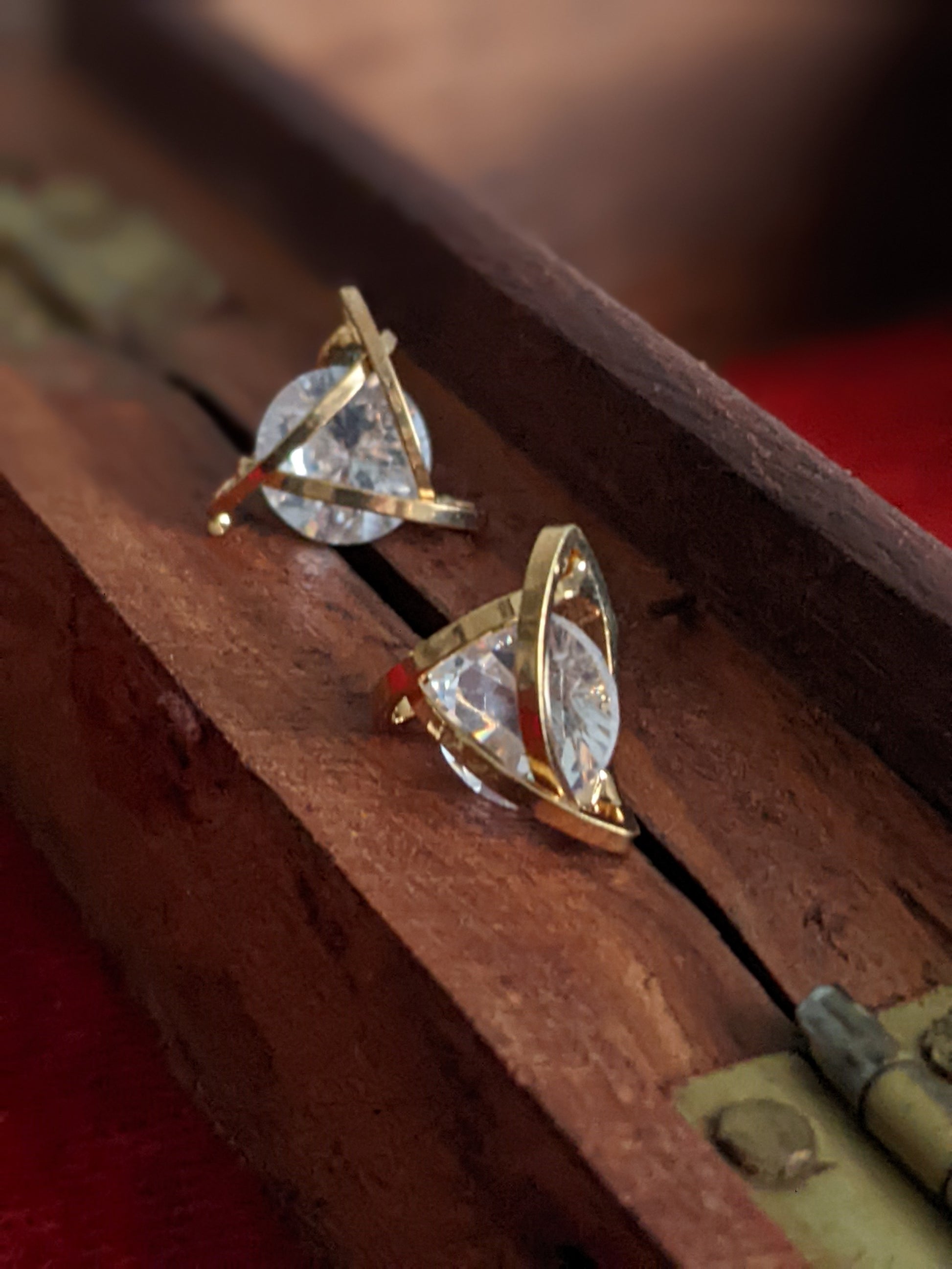 Small golden stud earrings with a modern design for everyday wear