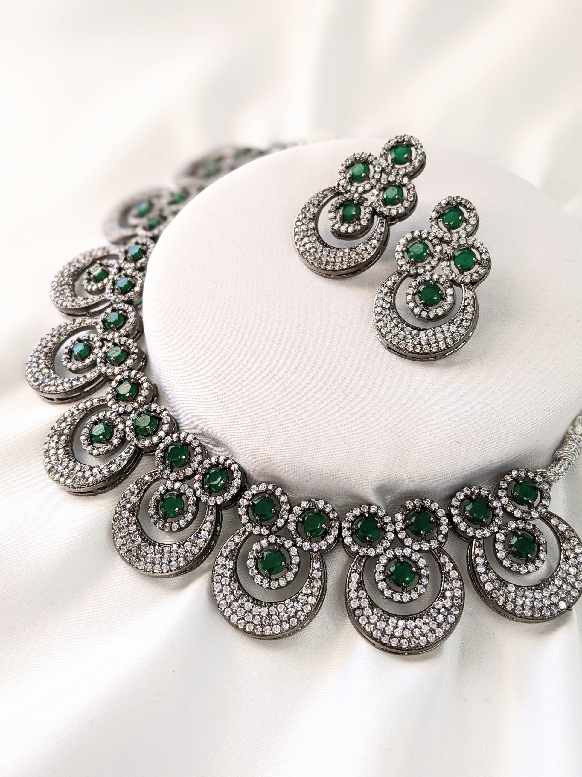 Very elegant American Diamond necklace with green Emerald look-alike statement stones. Set in black metal base, this necklace is sheer elegance!