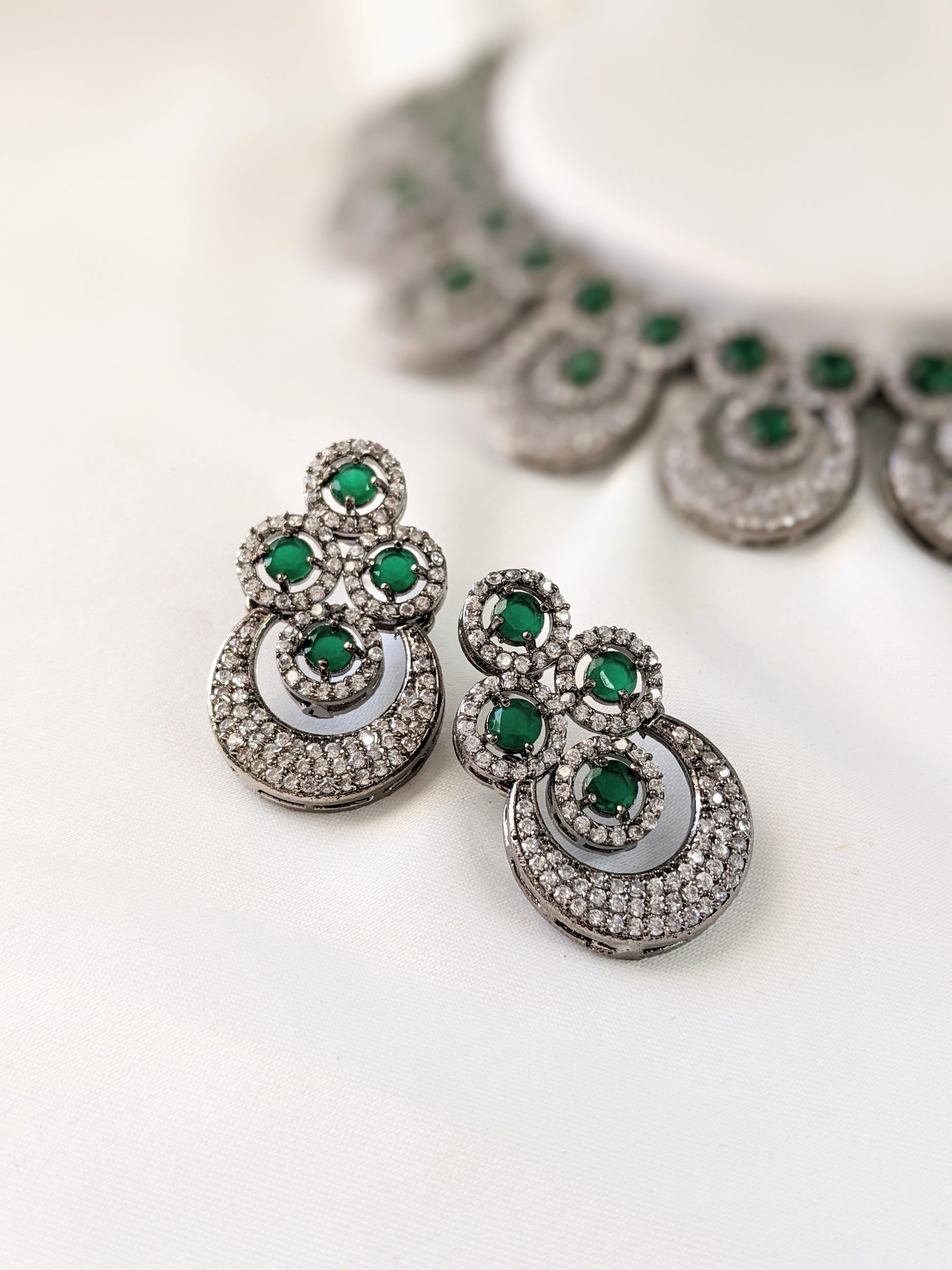 Very elegant American Diamond necklace with green Emerald look-alike statement stones. Set in black metal base, this necklace is sheer elegance!