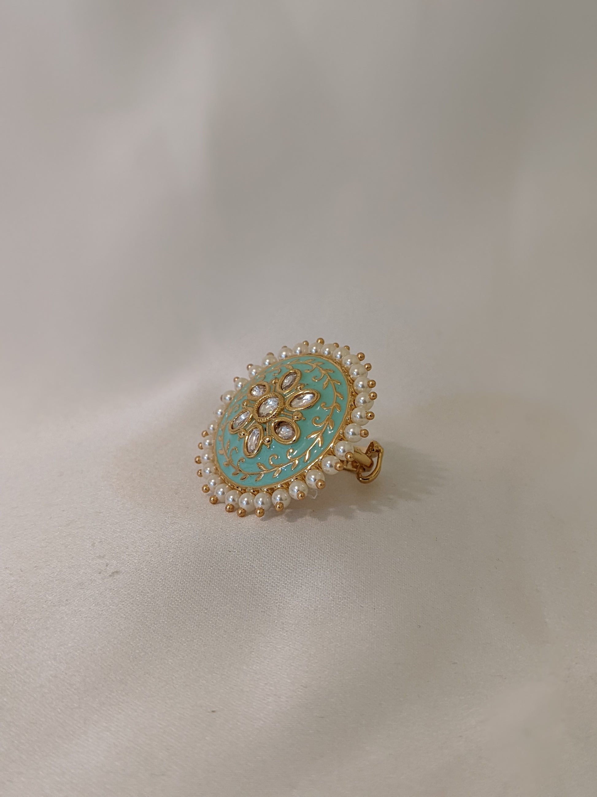 Golden kundan ring with green shouts royal
