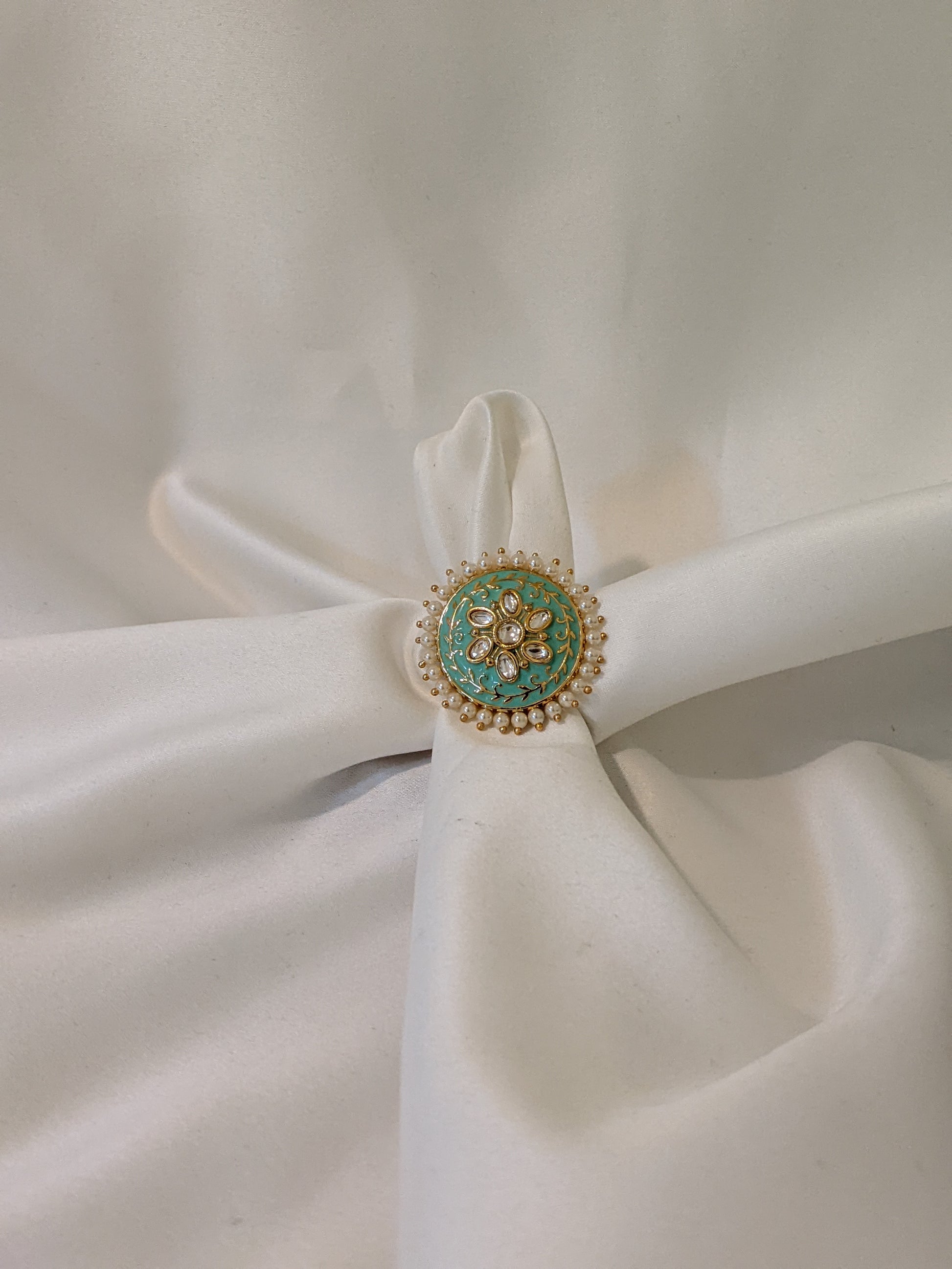 Golden kundan ring with green shouts royal