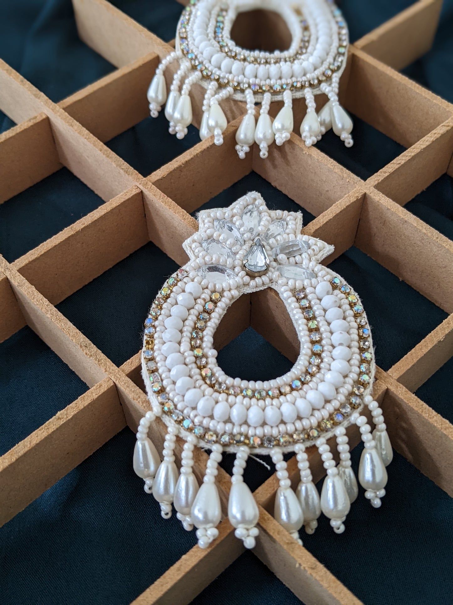 Bohemian fabric earrings in white & golden, these feather weight earrings are perfect for a quirky look when you wana give rest to your ears but still make a statement. And by feather weight we mean the material used is fabric, so they are literally feather weight