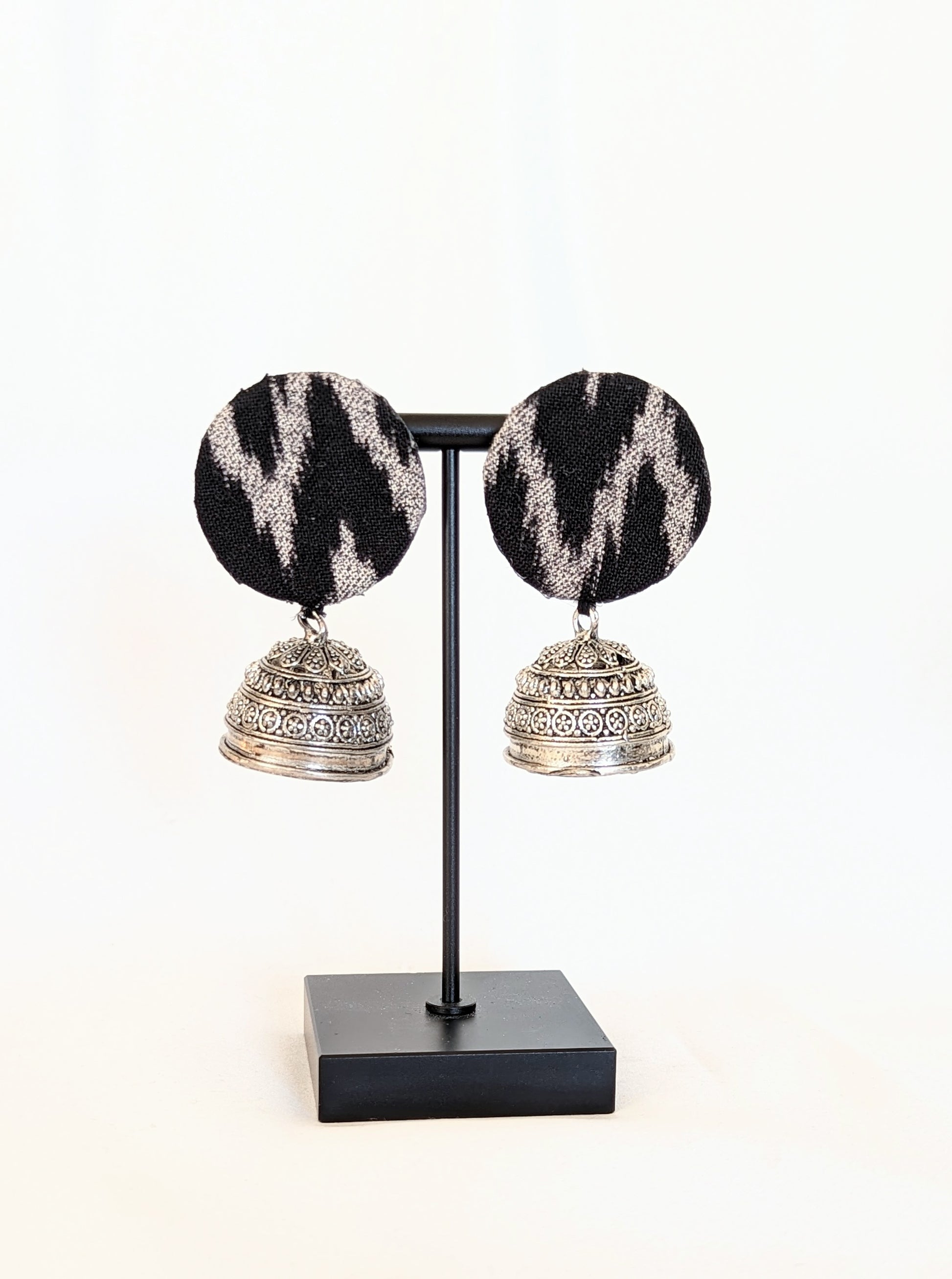 A pair of black ikat fabric earrings with a silver-colored hook and patterned design. Pick-up in Ajax Ontario. Worldwide shipping available. Perfect for wedding, festival jewelry, indian Jewelry, kids jewelry, kundan jewelry, gifting, costume jewelry, fashion jewelry, Eid, onam, Diwali, karwachauth, navratri. Free shipping available. Jewelry for women. Indian jewelry in ajax durham region.