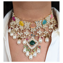 Load image into Gallery viewer, Elevate any ensemble with this luxurious multicolored necklace that adds an element of refinement and sophistication. Statement necklace with pearls &amp; green stones, comes with matching earrings and tikka.
