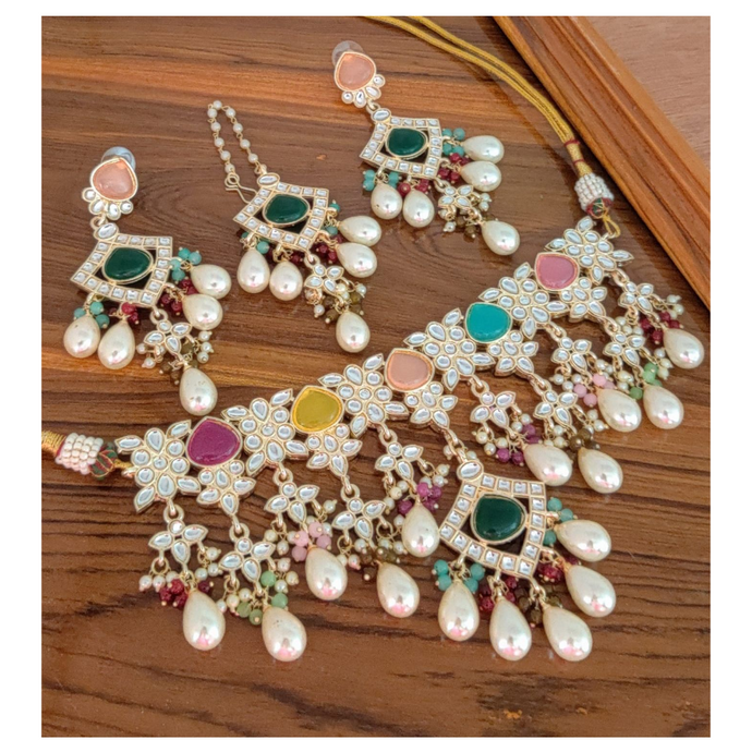 Elevate any ensemble with this luxurious multicolored necklace that adds an element of refinement and sophistication. Statement necklace with pearls & green stones, comes with matching earrings and tikka.