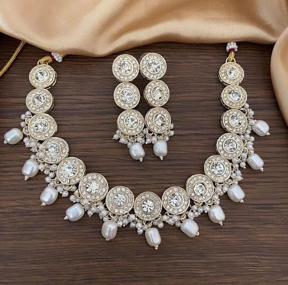 Sleek & elegant uncut polki lookalike necklace with white pearl detailing & danglers.