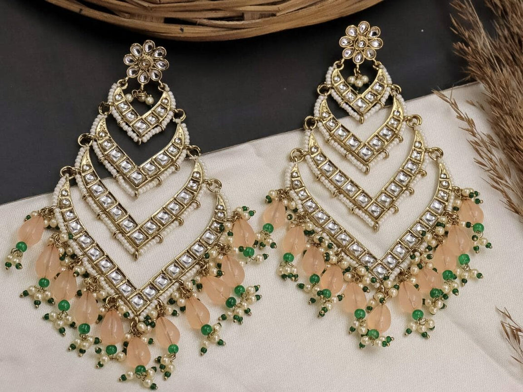 Statement long kundan earrings with green and Peach detailing. Extremely lightweight for their size.