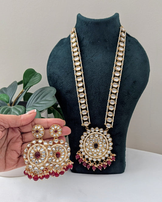A red kundan necklace with a gold-colored circular pendant and long pearl elements. Available for pickup in Ajax, Ontario and worldwide shipping.