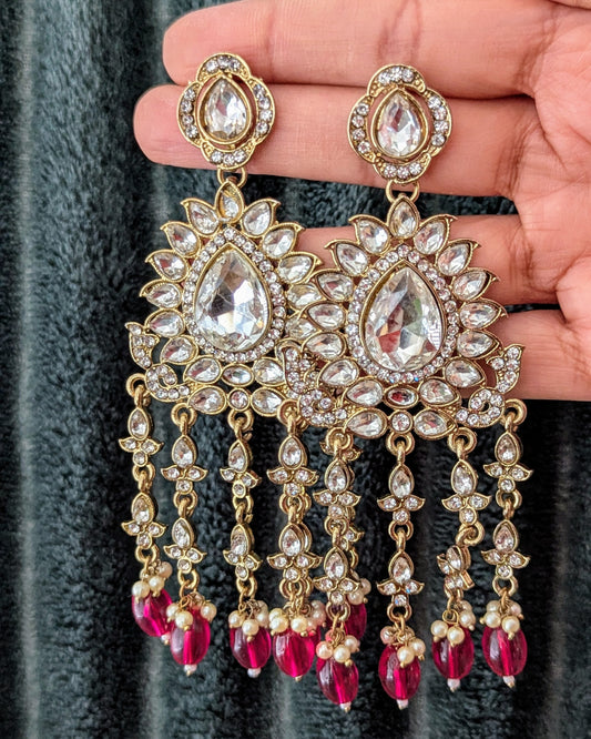 Statement zirconia chandbali danglers in pink/red. Perfect to match with any outfit or wear it as a contrast to a different color. Available for pick-up in Ajax, Ontario with worldwide shipping available. Pick-up in Ajax Ontario. Worldwide shipping available. Perfect for wedding, festival jewelry, indian Jewelry, kids jewelry, kundan jewelry, gifting, costume jewelry, fashion jewelry, Eid, onam, Diwali, karwachauth, navratri. Free shippi