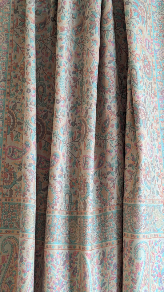 A beige lohi with multicolor patterns displayed.
