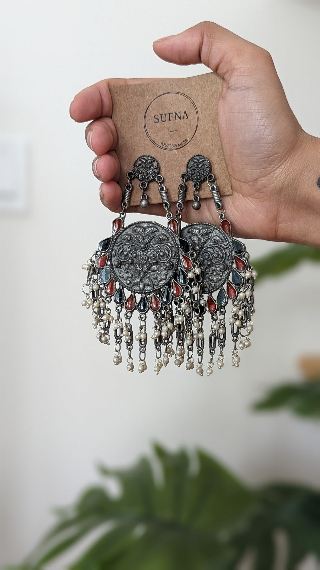 Afghani earrings in dark oxidized color with red and blue stones.