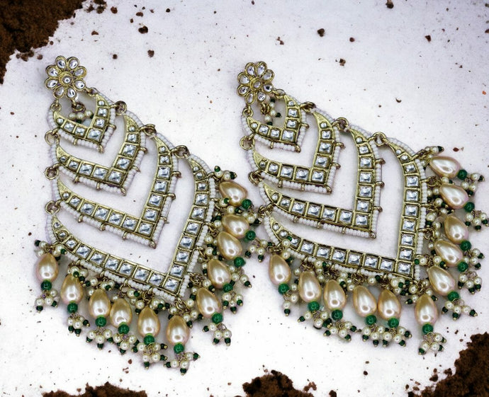 Statement long kundan earrings with green detailing. Extremely lightweight for their size.