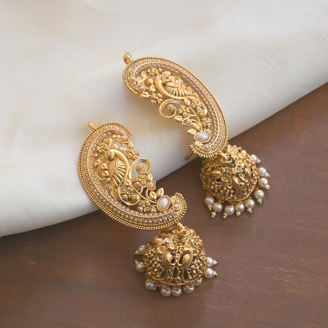 Very uniquely designed golden earcuff earrings. The upper part of the jhumki goes over the ear like an earcuff.
